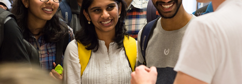 Smiling students from all over the world in conversation
